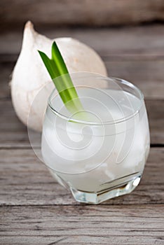 Fresh coconut juice in a glass with coconut white meat isolated on white