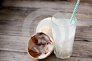 Fresh coconut juice in a glass with coconut white meat isolated on white