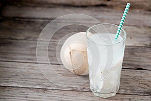 Fresh coconut juice in a glass with coconut white meat isolated on white