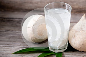 Fresh coconut juice in a glass with coconut white meat isolated on white