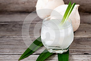 Fresh coconut juice in a glass with coconut white meat isolated on white