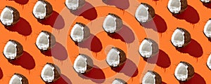 Fresh coconut in pattern on the orange background. Fresh fruits. Top view  .Healthy and tasty. Continous pattern, isolate, flat