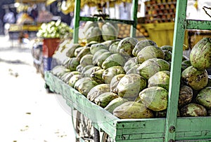 Fresh coconuts pile up on a street vendor cart in Sarnath