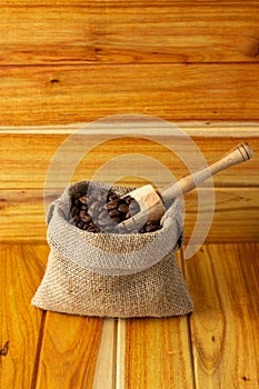 fresh coffee beans in cloth sacks - sack with coffee beans and wooden spoon