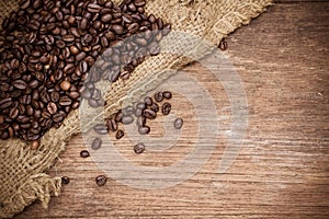 Fresh coffee beans on wood background