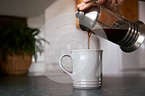 Fresh coffee being poured from a cafetiere photo