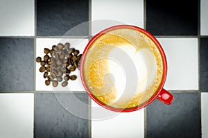 Fresh Coffee Cup with coffee beans on Checkedboard