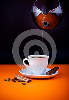 Fresh coffee cup filling from coffeepot photo