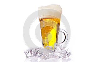 Fresh cold beer with ice and foam