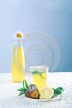 Fresh cold lemonade with mint leaves and cookies