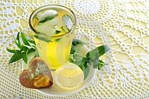 Fresh cold lemonade with mint leaves and cookies