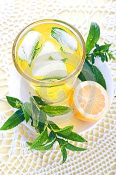 Fresh cold lemonade with mint leaves and lemon.
