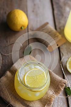 Fresh cold lemonade on a wooden background