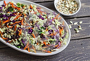 Fresh Cole slaw with pumpkin, flax, sesame seeds and pine nuts - delicious healthy vegetarian food.