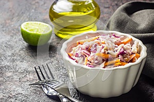 Fresh coleslaw salad made of shredded red and white cabbage and carrots