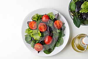 fresh colored cherry tomato salad with arugula, Basil, spinach, salad and olive oil dressing. selective focus