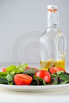 fresh colored cherry tomato salad with arugula, Basil, spinach, salad and olive oil dressing. selective focus