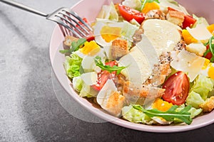 Fresh colored salad ceasar with metal fork