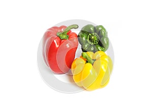 Fresh colorful bell peppers in three different colors of green, red and yellow on a white background. With the glow of lighting.