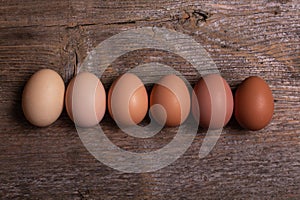 Fresh colorful eggs in a wooden background