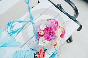 Fresh colorful flowers bouquet on white wooden chair. Flower bouquet with elephant box