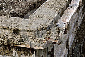 Fresh concrete poured into forms needing to be troweled