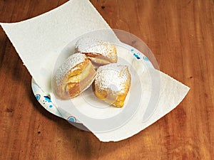 Fresh cooked beignets covered with powdered sugar.