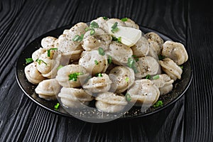 fresh cooked dumplings on a black wooden rustic background