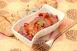 A stew of red beans, meat and corn