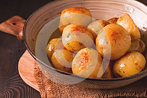 Fresh Cooked, new potatoes,with dill, on a wooden table, selective focus. close-up, toning, no people,