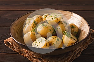 Fresh Cooked, new potatoes,with dill, on a wooden table, selective focus. close-up, toning, no people,