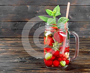 Fresh cool drink of ripe juicy cherry, strawberry, currant and gooseberry berries