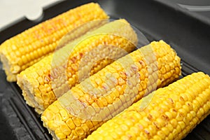 Fresh corn cobs on grill pan