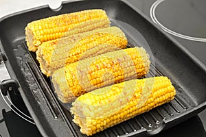 Fresh corn cobs on grill pan