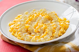 Fresh corn kernels in white bowl