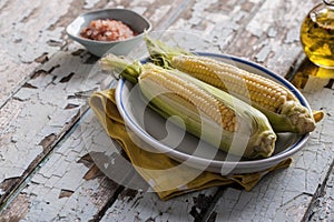 Fresh corn on a wood table