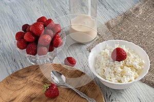 Fresh cottage cheese in a bowl of strawberries.