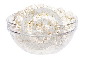 Fresh cottage cheese (curd) in glass bow, isolated on white