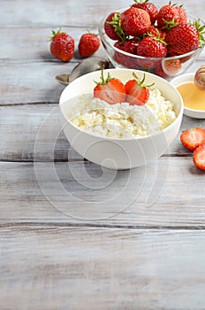 Fresh cottage cheese with fresh strawberries, healthy breakfast concept