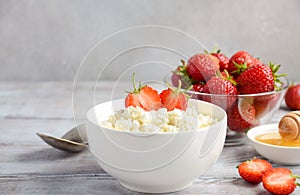 Fresh cottage cheese with fresh strawberries, healthy breakfast concept