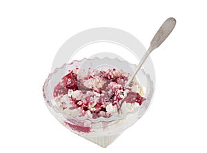 Fresh cottage cheese with strawberry jam in the glass bowl isolated on white background with silver spoon