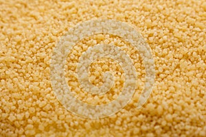 Fresh couscous on a white acrylic background