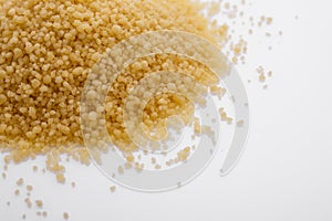 Fresh couscous on a white acrylic background