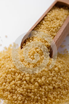 Fresh couscous on a white acrylic background