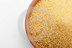 Fresh couscous on a white acrylic background