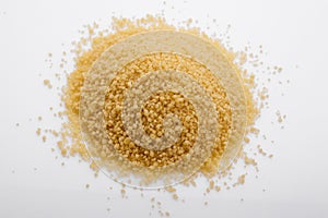 Fresh couscous on a white acrylic background