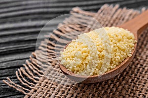 Fresh couscous on a wooden rustic background