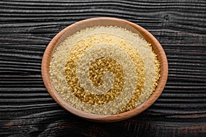 Fresh couscous on a wooden rustic background