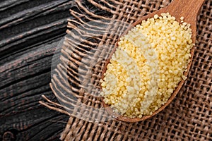 Fresh couscous on a wooden rustic background