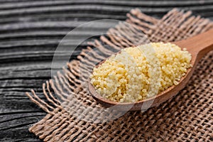 Fresh couscous on a wooden rustic background